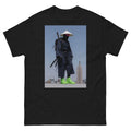 Black t-shirt with a graphic of a person in traditional attire with modern cityscape background